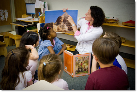 montessori teacher showing picture of sphinx to kindergarten students