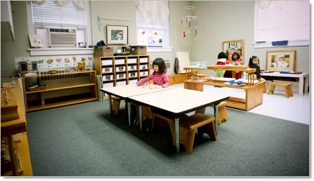 prek school girl in classroom sitting at desk