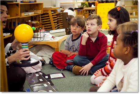 Montessori kindergarten students learning from teacher