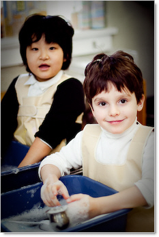 two prek kids washing their hands